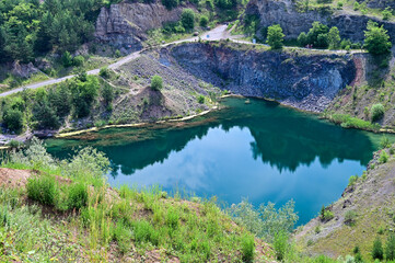 Fototapeta na wymiar The Emerald Lake or Lacul de Smarald - wonderfully turquoise lake in a beautiful landscape near Racos, Brasov, Transylvania, Romania
