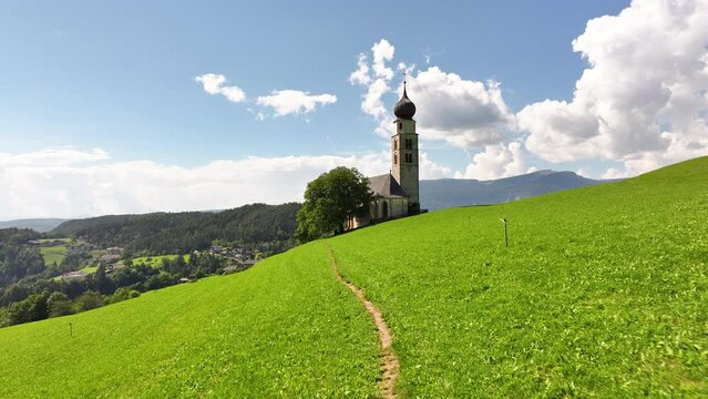 Amazing nature landscape in the Italian Alps. Wonderful summer view of St. Valentin Church on alpine meadow in Kastelruth. Location Dolomites, Alps, Bolzano, South Tyrol, Italy, Europe