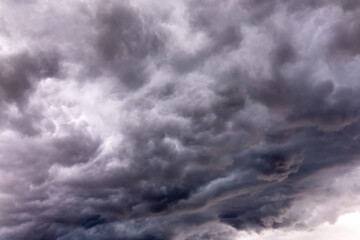 Naklejka na ściany i meble Dramatic dark clouds short before a thunderstorm and heavy rain