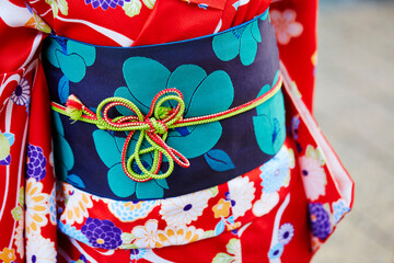 Back view of woman wearing yukata at temple