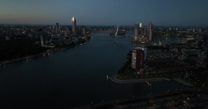 Aerial images of the Nieuwe Maas at night, the river running through the city of Rotterdam, and the port city skyline