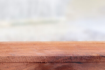 Wooden table with blurred white background for product display concept. 