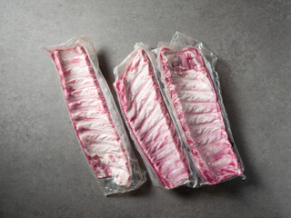 Raw back ribs packed in vacuum packs