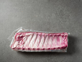 Raw back ribs packed in vacuum packs