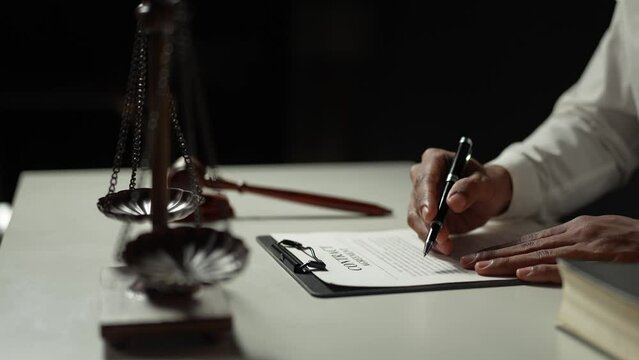 Young lawyer or legal advisor is reading and carefully checking the validity of documents and investment agreements for signing contracts managing justice concepts.