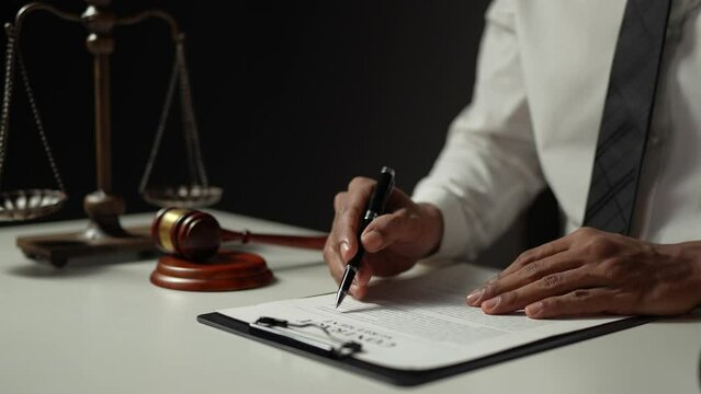 Young lawyer or legal advisor is reading and carefully checking the validity of documents and investment agreements for signing contracts managing justice concepts.