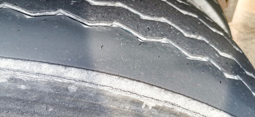 A used tire with visible signs of expiration