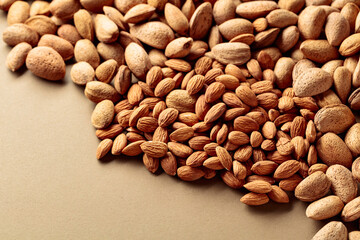 Almonds on a brown background.