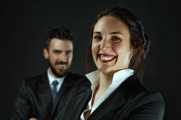 Woman, man represent professionalism on dark background