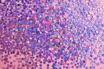 Purple sparkles on a pink background.