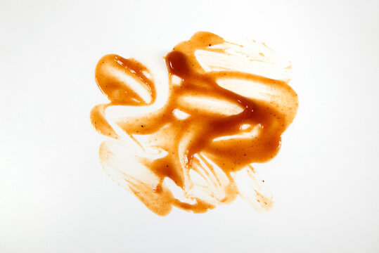 Abstract smears of red tomato sauce isolated on white, as texture or background.