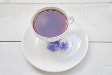 Delicious chicory drink, cups and saucers on a wooden table with a place to copy. A healthy drink made from chicory. High quality photo