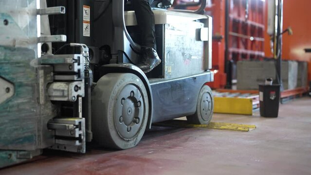 Close up of a forklift reversing in a warehouse