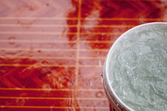 Rain is falling in a bucket full of water.Rainwater harvesting.Rainy season is coming.
