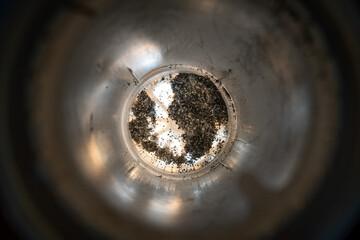 Remains of filter material at the bottom inside the replacement household filter cartridge. Ion...