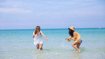 splash water. Happy Couple  or friends Running and traveller enjoy life on Tropical Beach.