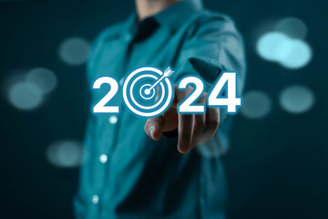 Businessman shows business goals for 2024 on a 2024 light bulb. Analytical plans business growth in 2024, digital marketing strategy, revenue, profits, economy, stock market and business trends....	

