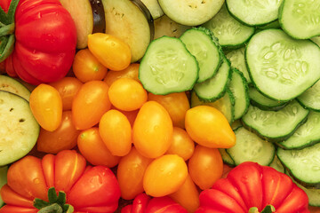 Mixed fresh vegetable background. Healthy eating ingredients. Slice of mix veggies, tomatoes, cucumbers, cherry tomato, eggplant. Nutrition, diet, vegan food. Assorted fruits rotating view closeup