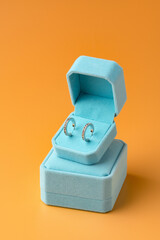 Blue jewelry box on yellow background close up