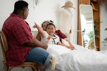 A plus-size family with a father wearing a prosthetic leg, Tell stories to lull daughter to sleep...