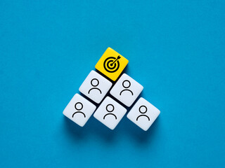 Teamwork and achieving corporate business goals concept. Employee and target goal symbols on...