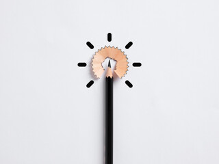 Idea, creativity, brainstorming, learning and education concepts. Black pencil and shaving representing light bulb idea shape.