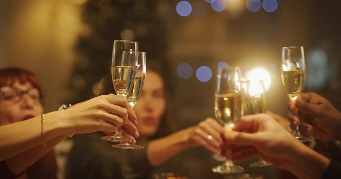 Close Up Of Parents, Children And Friends Raising Glasses With Champagne, Toasting, Celebrating A Winter Holiday. Guests Enjoying Christmas Dinner Together In A Cozy Home In The Evening