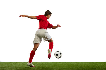 Fototapeta premium Winning game. Young athletic girl, football player in motion during game, playing isolated over white background