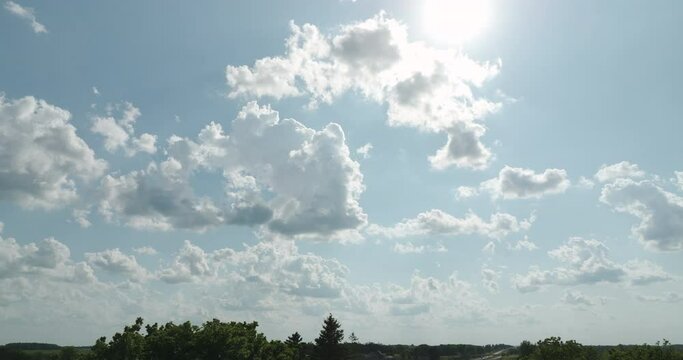 Serene scenery of a peaceful Cumulus clouds over a slowly moving land.