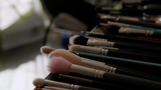 Close up of Professional make up brushes on the table. Move camera