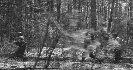 American Soldiers Of USA Infantry Of World War II Marching Running Run Along Forest In Autumn Spring Day. Group of US soldiers.