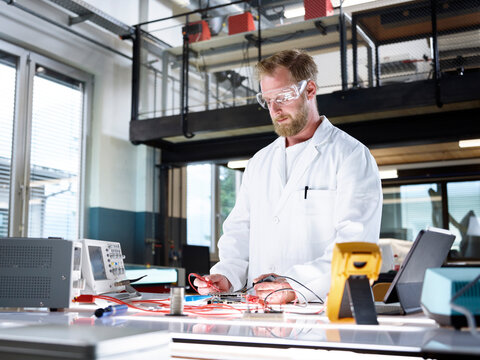Scientist working on circuit board in laboratory