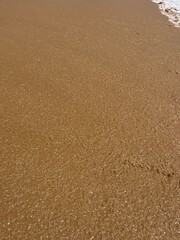 wet sand at the sea coast, natural sea sand texture
