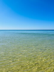Calm transparent sea surface, blue sea horizon