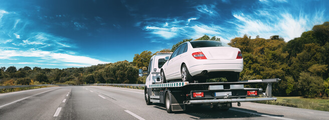 Car Service Transportation Concept. Tow Truck Transporting Car Or Help On Road Transports Wrecker Broken Car. Auto Towing, Tow Truck For Transportation Faults And Emergency Cars . Tow Truck Moving In