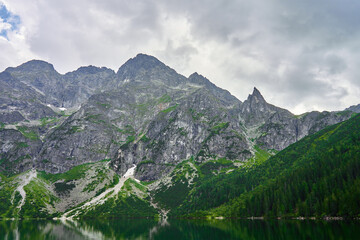 Amazing view on mountains range near beautiful lake at summer day. Tatra National Park in Poland. Panoramic view on Morskie Oko or Sea Eye lake in Five lakes valley