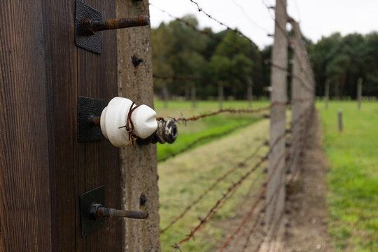Auschwitz, Poland, September 18, 2021: Barbed wire surrounding the Auschwitz-Birkenau concentration camp. Stakes.