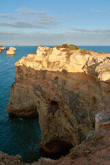 Fototapeta na wymiar Natural limestone arch near the beach Praia da Marinha. Algarve, Portugal