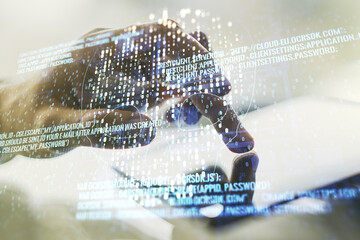 Double exposure of creative code skull hologram and finger clicks on a digital tablet on...