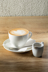 cup of cappuccino on wooden table