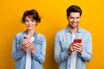 Photo of cute sweet couple best friends wear stylish denim clothes use iphone read instagram...