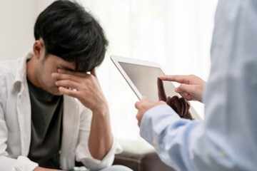 man with mental health problems is consulting. psychiatrist is recording the patient's condition...