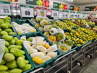Pile of tropical fruit, Green mango, Papaya, Tangerine in a local market in Thailand, Organic mango...