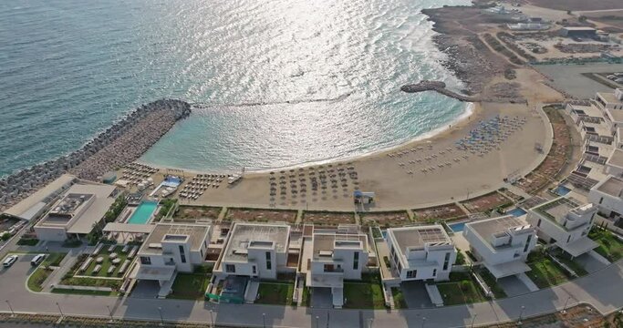 Aerial view of Ayia Napa, Cyprus. Beautiful luxury hotels near the marina with yachts and motor boats, tourism and recreation at sea. High quality 4k footage