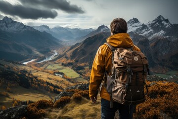 Fototapeta na wymiar Rear view man hiking at sunset mountains with heavy backpack Travel Lifestyle wanderlust adventure concept summer vacations outdoor alone into the wild