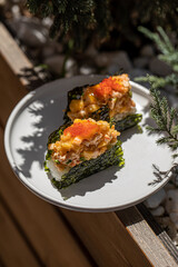 Portion of appetizing trendy sushi hand rolls with caviar