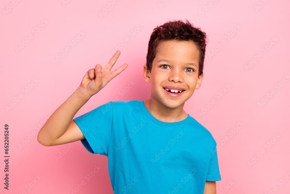 Wall mural Photo portrait of pretty schoolboy showing excited hi v-sign wear trendy blue outfit isolated on pink color background