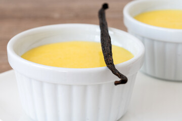 Homemade vanilla custard on wooden table background