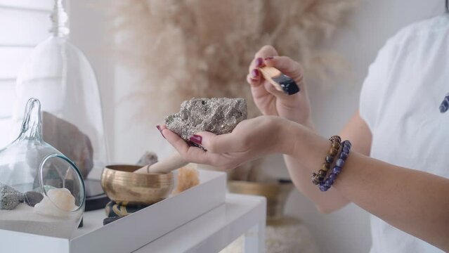 Woman Holding A Quartz Gemstone And Palo Santo for abundance and meditation Ritual Holistic of crystal healing whit pyrthite quartz