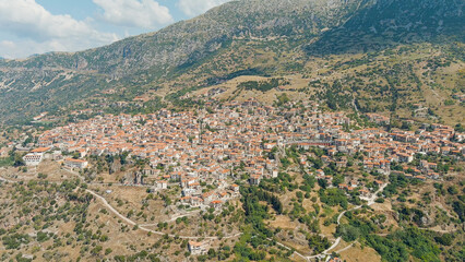 Fototapeta na wymiar Arachova, Greece. Arachova is a small town in Greece, in the community of Distomon-Arachova-Andikira. Sunny weather with clouds. Summer, Aerial View